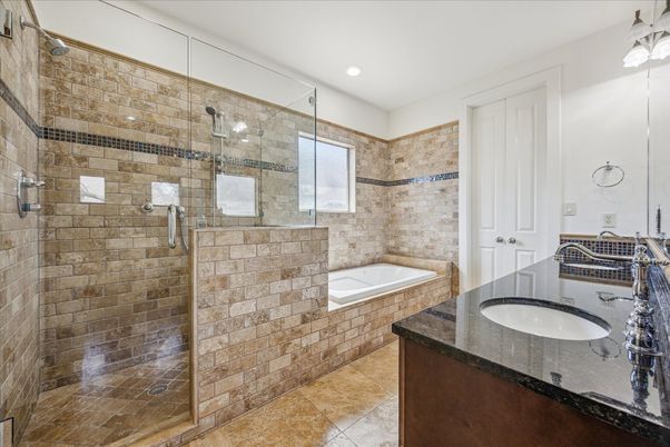 Bathroom, Dual Sink Vanities, Glass Shower, Interior, Recessed Lighting, Stone Walls