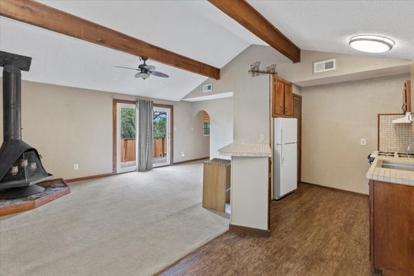 Empty room, Fireplace, Interior, Kitchen, Tile Countertops, Wooden Beams, Wood Texture Flooring