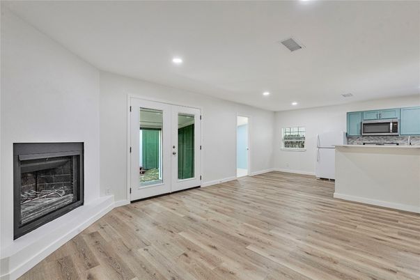 Empty room, Fireplace, Interior, Kitchen, Recessed Lighting, Wood Texture Flooring