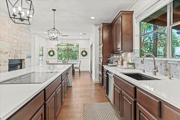 Chandelier, Fireplace, Interior, Kitchen, Pendant Lights, Recessed Lighting, Stone Walls, Wood Texture Flooring