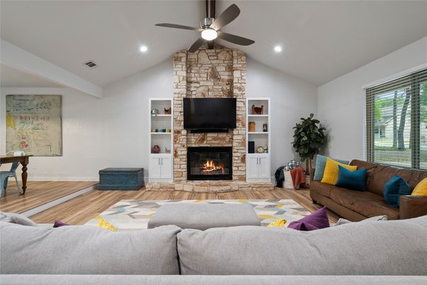 Fireplace, Interior, Living room, Recessed Lighting, Stone Walls, Wood Texture Flooring