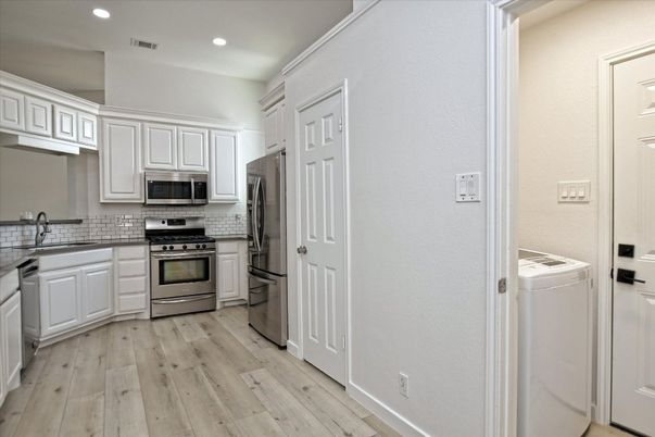 Interior, Kitchen, Recessed Lighting, Stainless Steel Appliances, Washer, Wood Texture Flooring