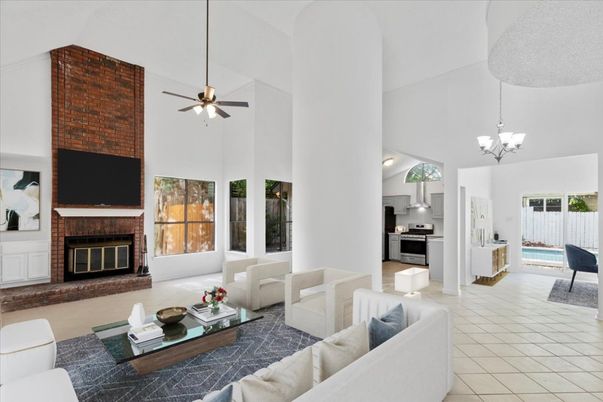 Chandelier, Fireplace, Interior, Kitchen, Living room, Pendant Lights, Stainless Steel Appliances, Stone Walls