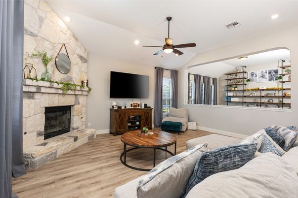 Fireplace, Interior, Living room, Recessed Lighting, Stone Walls, Wood Texture Flooring