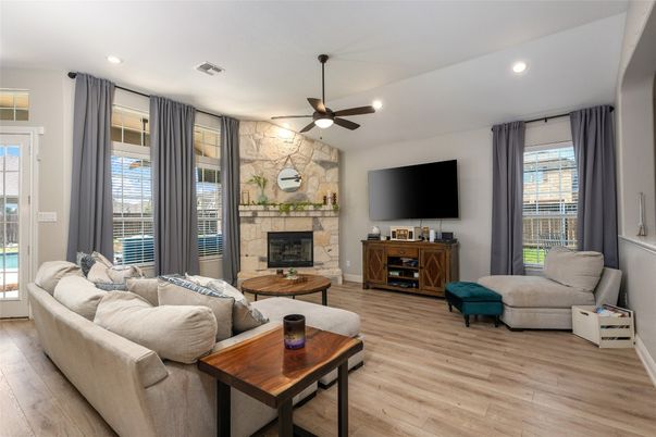 Fireplace, Interior, Living room, Recessed Lighting, Stone Walls, Wood Texture Flooring