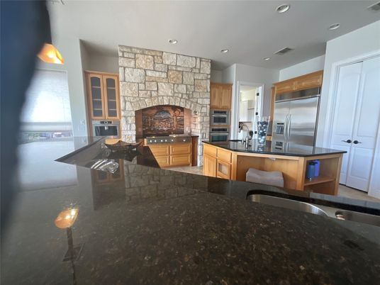 Fireplace, Interior, Kitchen, Recessed Lighting, Stainless Steel Appliances, Stone Walls