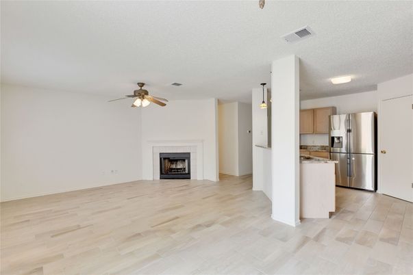 Empty room, Fireplace, Interior, Kitchen, Stainless Steel Appliances, Wood Texture Flooring