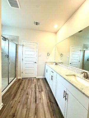 Bathroom, Dual Sink Vanities, Glass Shower, Interior, Recessed Lighting, Wood Texture Flooring