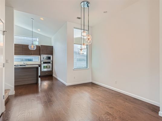 Empty room, Interior, Kitchen, Pendant Lights, Recessed Lighting, Stainless Steel Appliances, Wood Texture Flooring