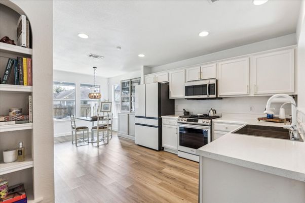 Chandelier, Dining room, Interior, Kitchen, Pendant Lights, Recessed Lighting, Stainless Steel Appliances, Wood Texture Flooring