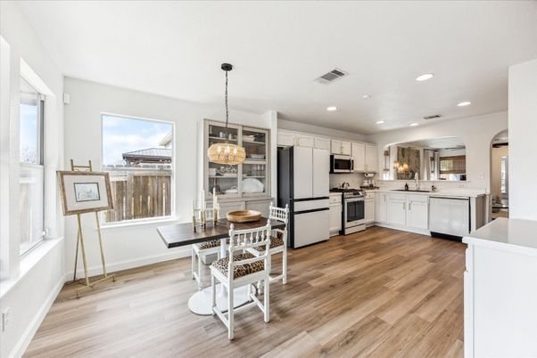 Chandelier, Dining room, Interior, Kitchen, Recessed Lighting, Stainless Steel Appliances, Wood Texture Flooring