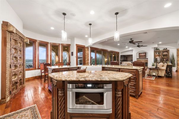Dining room, Fireplace, Interior, Kitchen, Pendant Lights, Recessed Lighting, Water, Wood Texture Flooring