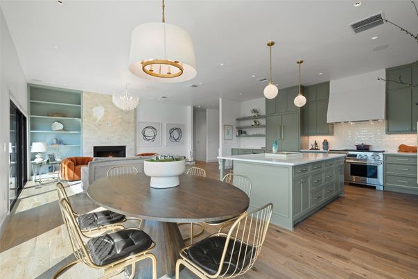 Chandelier, Dining room, Fireplace, Interior, Kitchen, Living room, Pendant Lights, Recessed Lighting, Stainless Steel Appliances, Stone Walls, Wood Texture Flooring
