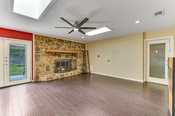 Empty room, Fireplace, Interior, Recessed Lighting, Stone Walls, Wood Texture Flooring