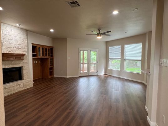 Empty room, Fireplace, Interior, Recessed Lighting, Stone Walls, Wood Texture Flooring