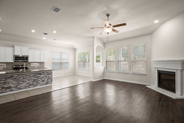 Empty room, Fireplace, Interior, Kitchen, Recessed Lighting, Stainless Steel Appliances, Wood Texture Flooring