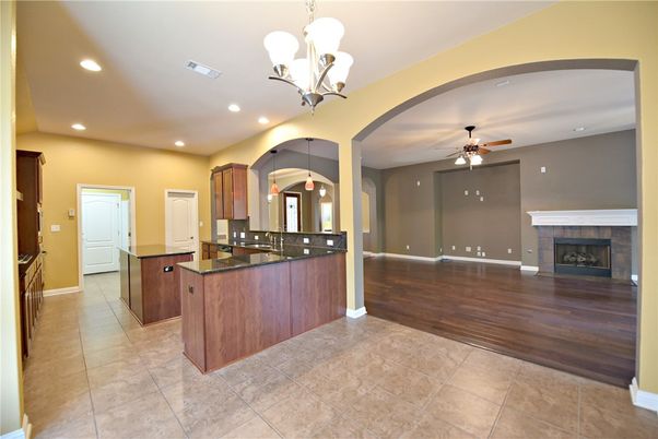 Chandelier, Empty room, Fireplace, Interior, Kitchen, Recessed Lighting, Wood Texture Flooring