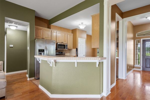 Interior, Kitchen, Stainless Steel Appliances, Tile Countertops, Wood Texture Flooring