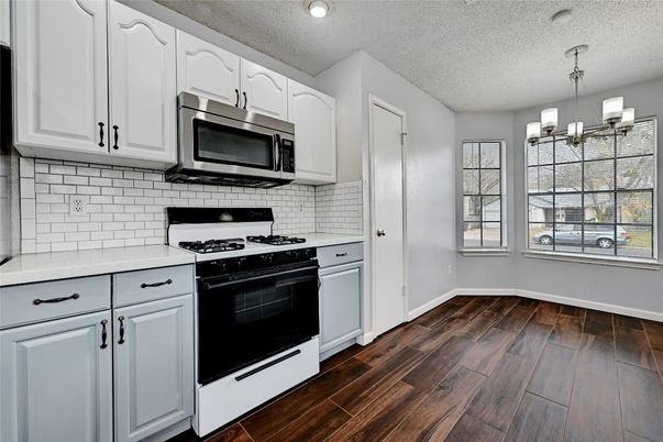 Chandelier, Interior, Kitchen, Pendant Lights, Stainless Steel Appliances, Wood Texture Flooring