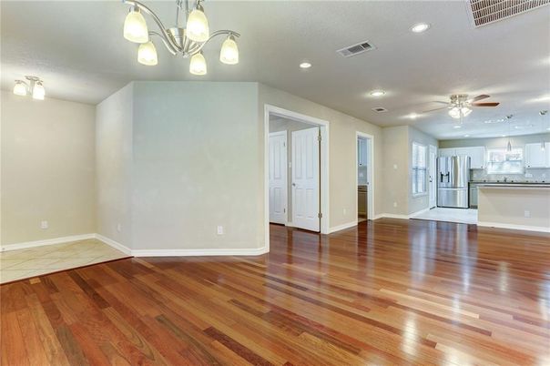 Empty room, Interior, Kitchen, Recessed Lighting, Stainless Steel Appliances, Wood Texture Flooring