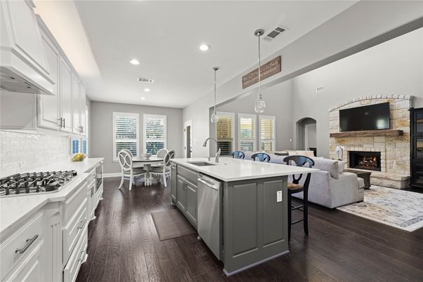Dining room, Fireplace, Interior, Kitchen, Living room, Pendant Lights, Recessed Lighting, Stainless Steel Appliances, Wood Texture Flooring