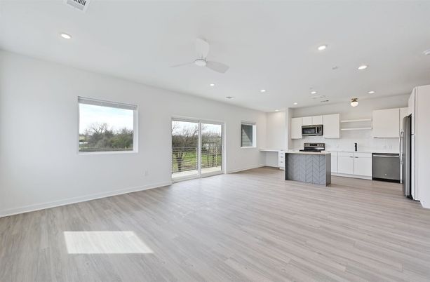 Empty room, Interior, Kitchen, Recessed Lighting, Stainless Steel Appliances, Wood Texture Flooring