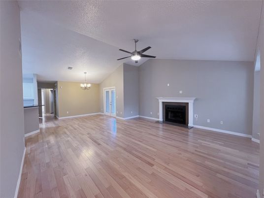 Chandelier, Empty room, Fireplace, Interior, Kitchen, Stainless Steel Appliances, Wood Texture Flooring