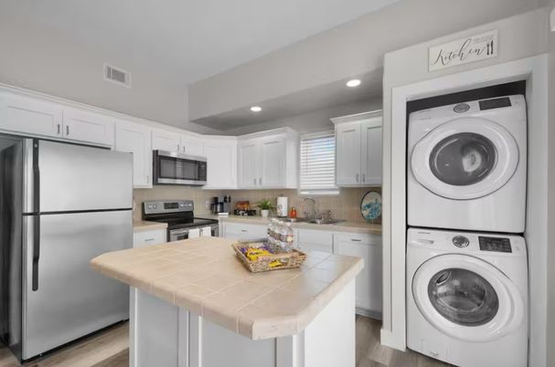Interior, Kitchen, Recessed Lighting, Tile Countertops, Washer, Wood Texture Flooring