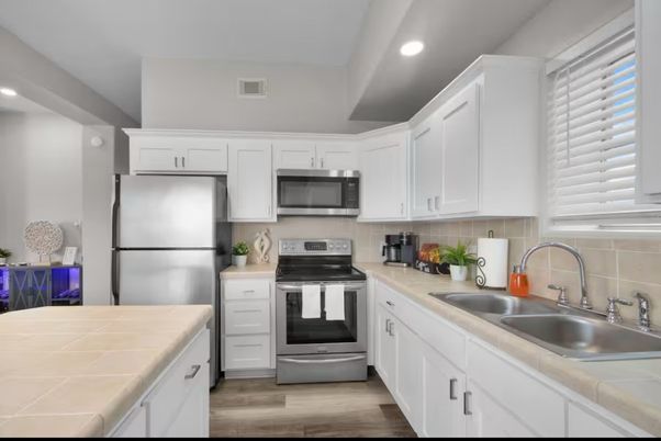 Interior, Kitchen, Recessed Lighting, Stainless Steel Appliances, Tile Countertops, Wood Texture Flooring