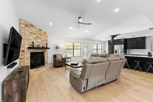 Fireplace, Interior, Kitchen, Living room, Recessed Lighting, Stainless Steel Appliances, Stone Walls, Wood Texture Flooring