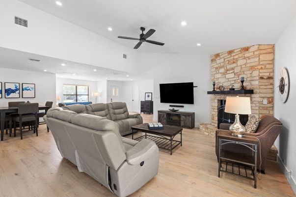 Dining room, Fireplace, Interior, Living room, Recessed Lighting, Stone Walls, Wood Texture Flooring