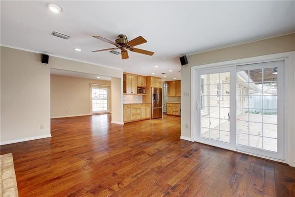 Empty room, Interior, Kitchen, Recessed Lighting, Stainless Steel Appliances, Wood Texture Flooring