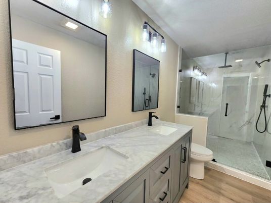 Bathroom, Dual Sink Vanities, Glass Shower, Interior, Marble Walls, Wood Texture Flooring