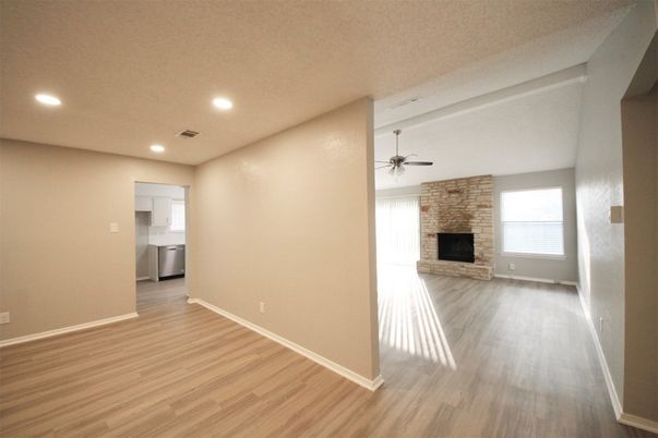 Empty room, Fireplace, Interior, Recessed Lighting, Stone Walls, Wood Texture Flooring