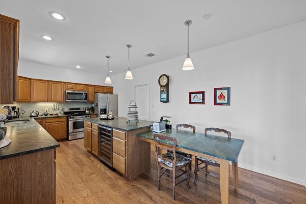 Dining room, Interior, Kitchen, Pendant Lights, Recessed Lighting, Stainless Steel Appliances, Wood Texture Flooring