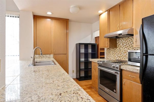 Interior, Kitchen, Recessed Lighting, Stainless Steel Appliances, Tile Countertops, Wood Texture Flooring
