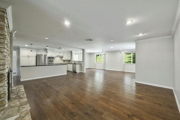 Empty room, Interior, Kitchen, Pendant Lights, Recessed Lighting, Stainless Steel Appliances, Wood Texture Flooring