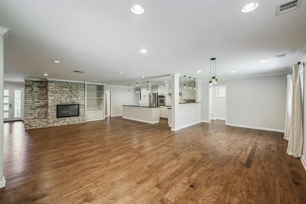 Empty room, Fireplace, Interior, Kitchen, Pendant Lights, Recessed Lighting, Stone Walls, Wood Texture Flooring