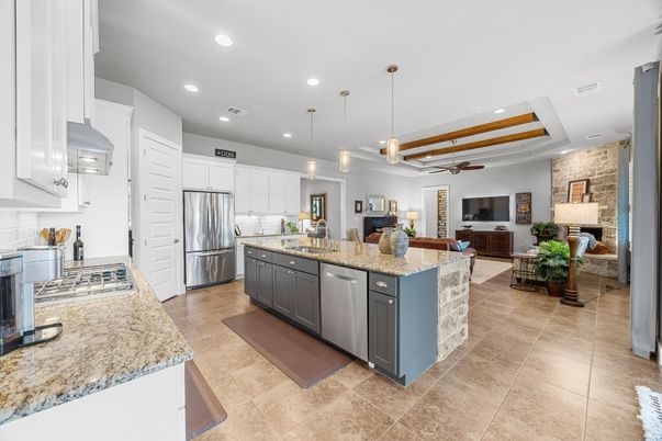 Fireplace, Interior, Kitchen, Living room, Pendant Lights, Recessed Lighting, Stainless Steel Appliances, Stone Walls