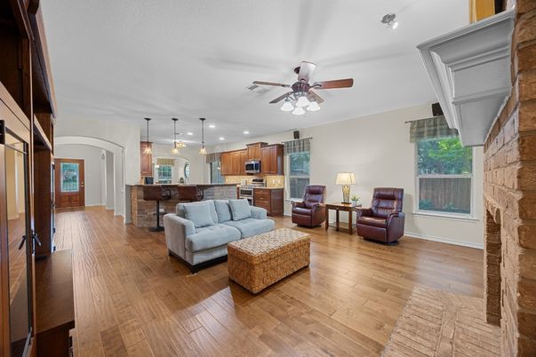 Fireplace, Interior, Kitchen, Living room, Pendant Lights, Recessed Lighting, Stainless Steel Appliances, Stone Walls, Wood Texture Flooring