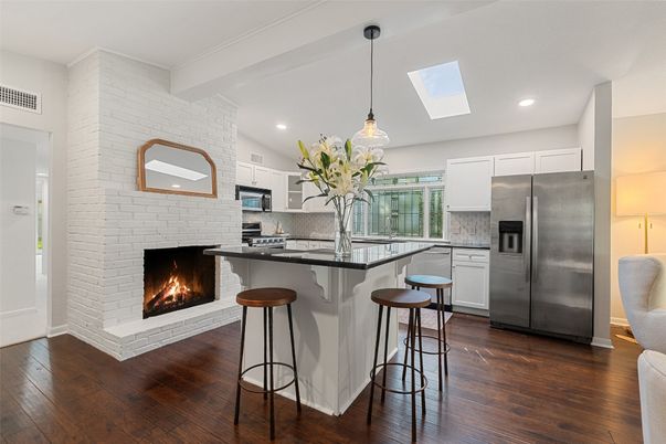 Fireplace, Interior, Kitchen, Pendant Lights, Recessed Lighting, Stainless Steel Appliances, Stone Walls, Wood Texture Flooring