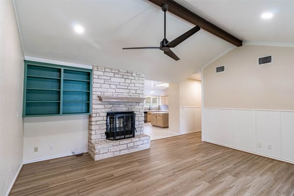 Empty room, Fireplace, Interior, Recessed Lighting, Stone Walls, Wooden Beams, Wood Texture Flooring