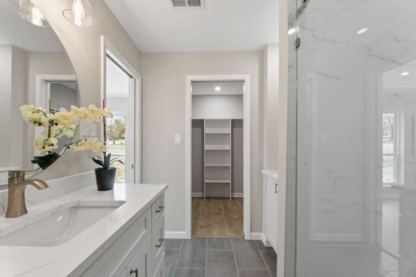 Bathroom, Dual Sink Vanities, Glass Shower, Interior, Marble Walls, Recessed Lighting, Wood Texture Flooring