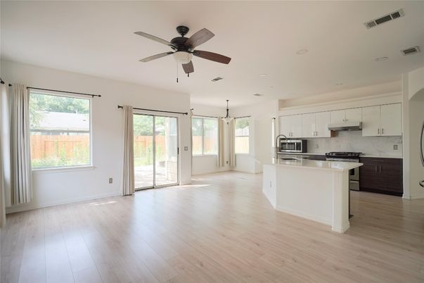 Empty room, Interior, Kitchen, Recessed Lighting, Stainless Steel Appliances, Wood Texture Flooring