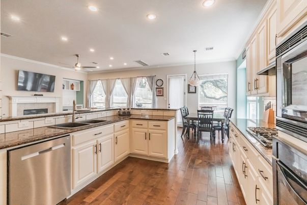 Dining room, Fireplace, Interior, Kitchen, Pendant Lights, Recessed Lighting, Stainless Steel Appliances, Wood Texture Flooring