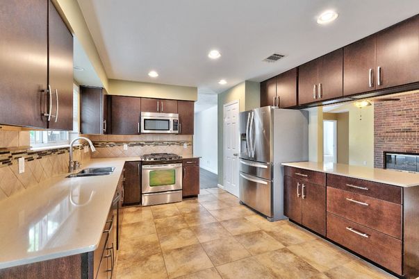 Fireplace, Interior, Kitchen, Recessed Lighting, Stainless Steel Appliances, Stone Walls