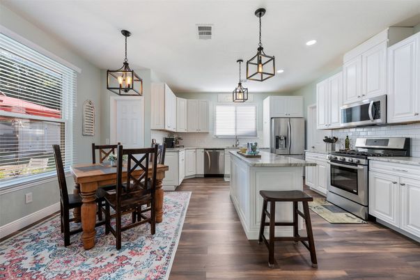 Dining room, Interior, Kitchen, Pendant Lights, Recessed Lighting, Stainless Steel Appliances, Wood Texture Flooring