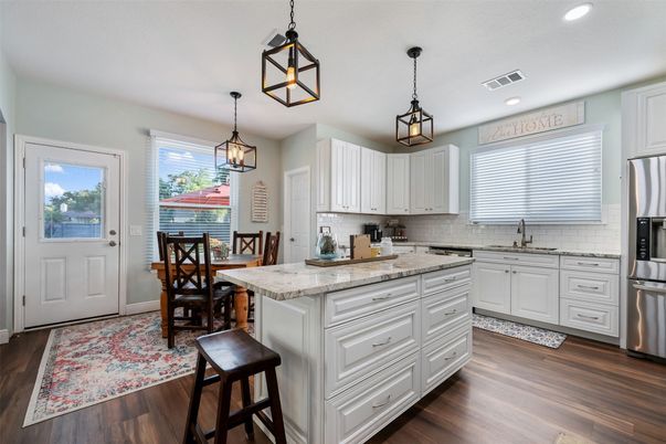 Dining room, Interior, Kitchen, Pendant Lights, Recessed Lighting, Stainless Steel Appliances, Wood Texture Flooring