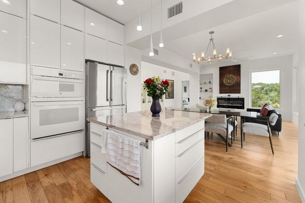 Chandelier, Dining room, Fireplace, Interior, Kitchen, Living room, Pendant Lights, Recessed Lighting, Stainless Steel Appliances, Wood Texture Flooring