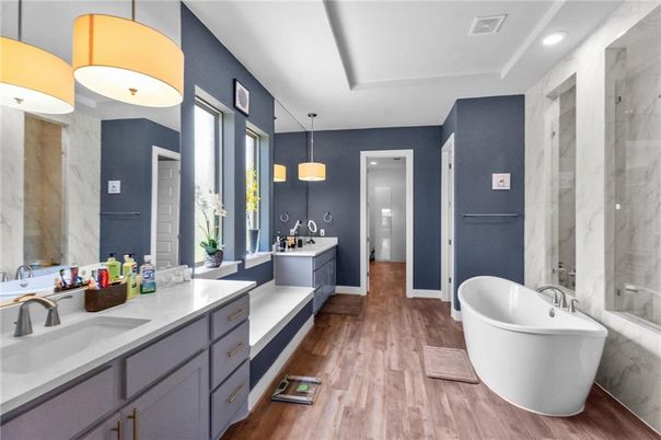 Bathroom, Dual Sink Vanities, Free Standing Baths, Interior, Marble Walls, Pendant Lights, Recessed Lighting, Wood Texture Flooring